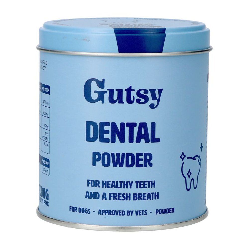 Boîte bleu clair avec "Gutsy Dental Powder". Texte pour dents saines et haleine fraîche. Symbole de dent.