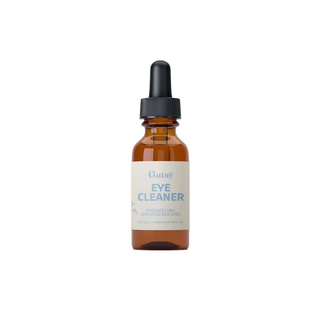 Flacon en verre brun avec compte-gouttes noir. L'étiquette indique "Gutsy Eye Cleaner" et "Hydrates dry, irritated dog eyes".
