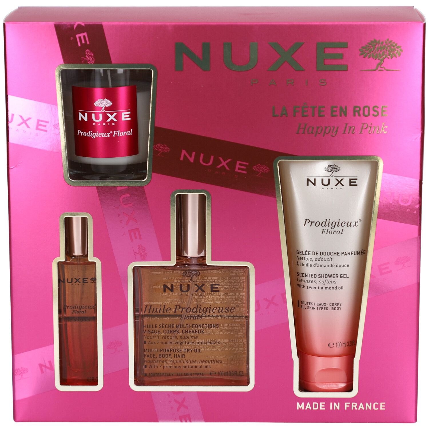 Coffret rose avec quatre produits. Visibles : flacon, huile, gel douche et bougie. Logo et texte Nuxe.