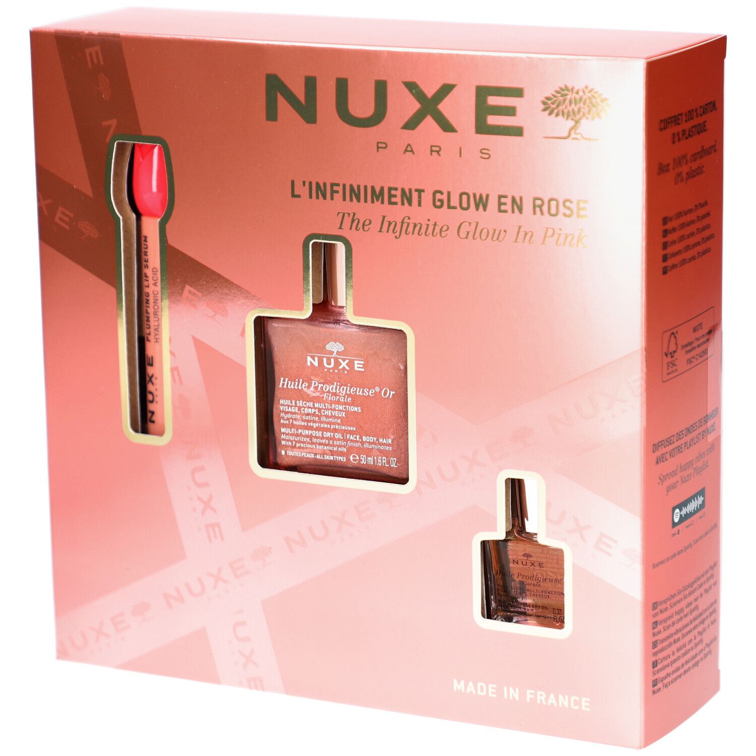Geschenkset mit drei Produkten in rosa Verpackung. Sichtbar: Lippenstift, Ölflasche und kleine Flasche. Text: Nuxe Paris.