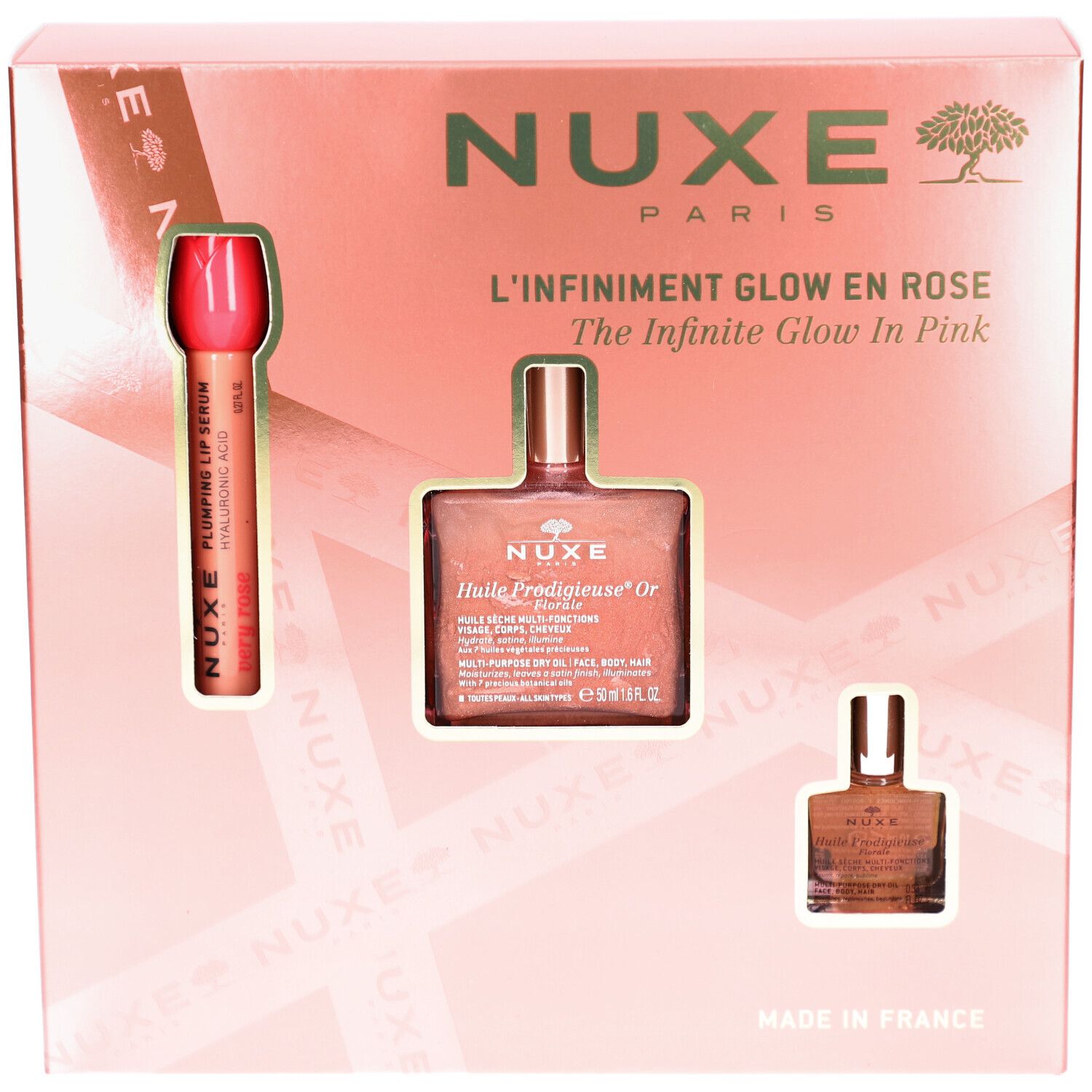 Rosa Geschenkbox mit drei Produkten. Sichtbar: Lippenstift, Ölflasche und kleine Flasche. Text: Nuxe Paris, Glow en Rose.
