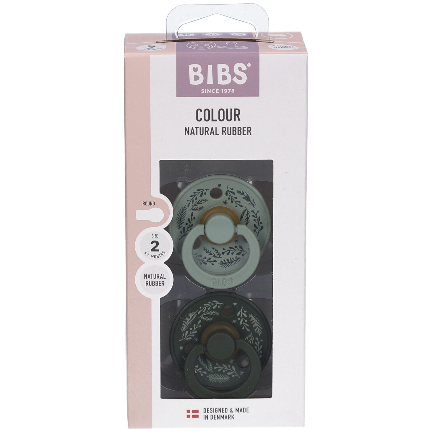 Verpackung mit zwei Schnullern. Marke BIBS, Schriftzug „COLOUR NATURAL RUBBER“. Größe 2, 6-18 Monate. Grün und dunkelgrün mit Blättermuster.