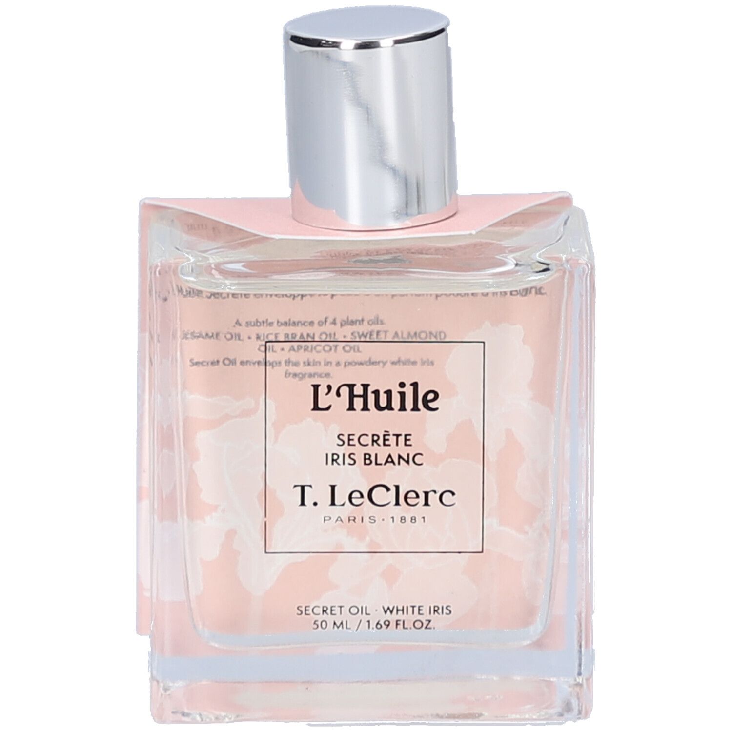 Quadratische Glasflasche mit silbernem Deckel. Aufkleber mit Text: L'Huile Secrète Iris Blanc, T. LeClerc. Rosa Verpackung mit floralem Muster.