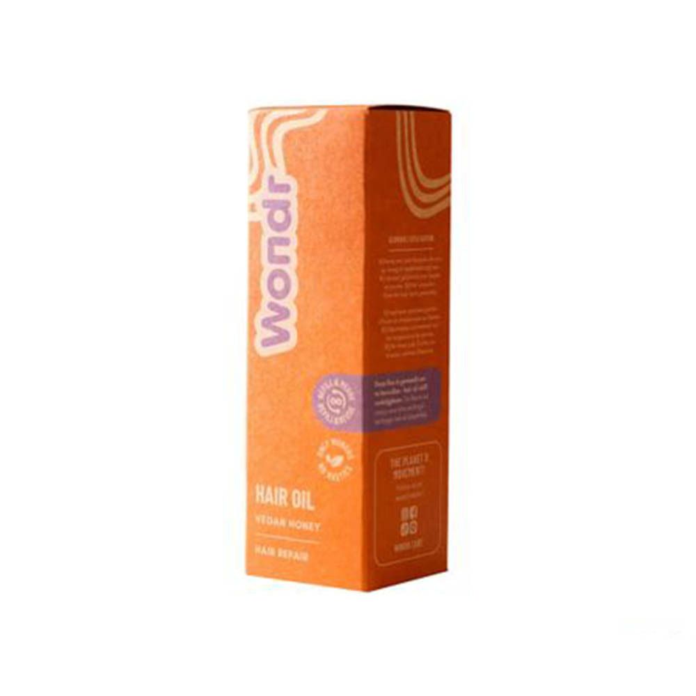 Emballage du produit. Boîte orange avec inscription : Wondr, Hair Oil, Vegan Honey, Hair Repair. Avec logo.
