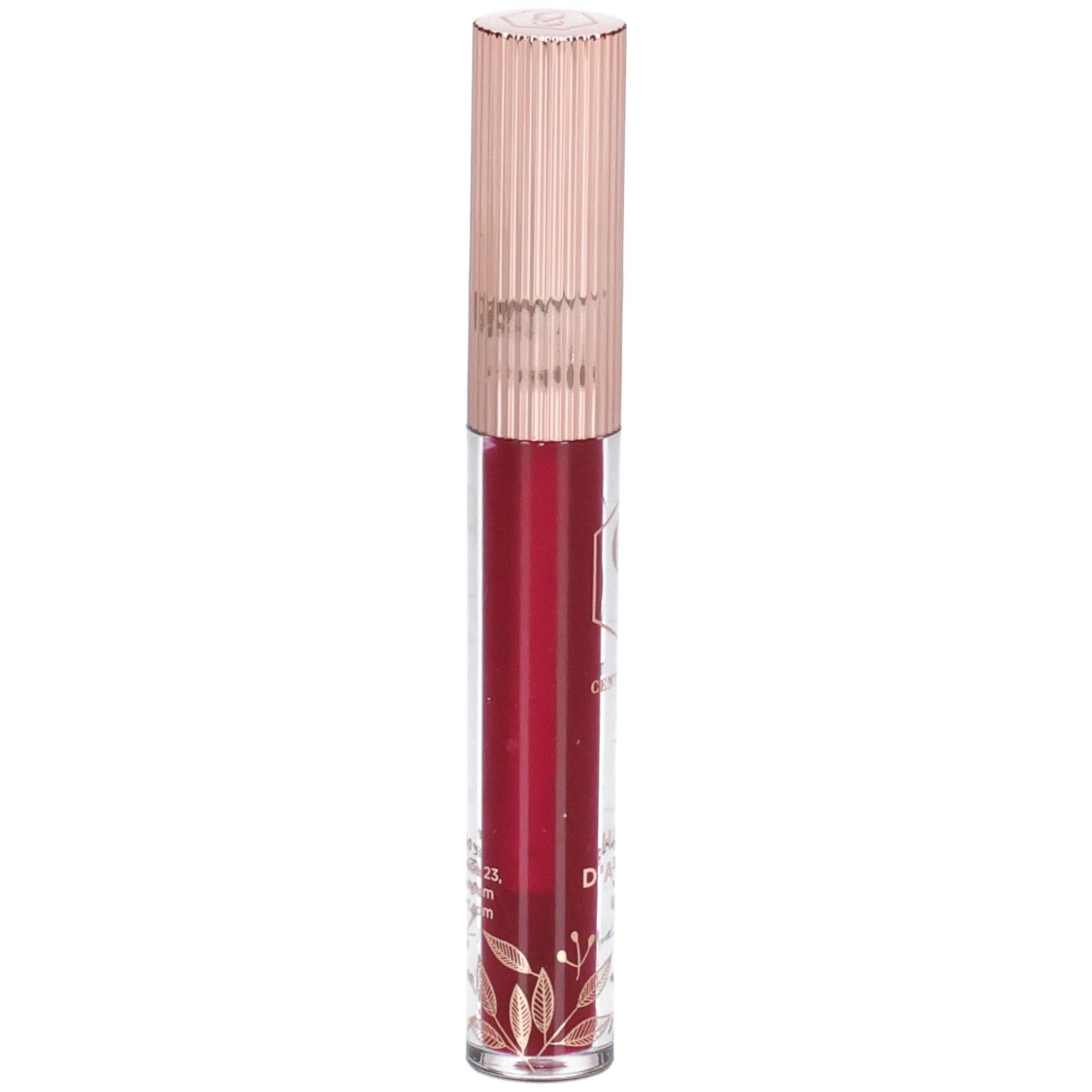 Huile à lèvres dans un flacon transparent avec un bouchon or rose. Le contenu est rouge. Des décorations dorées sont visibles sur le flacon.