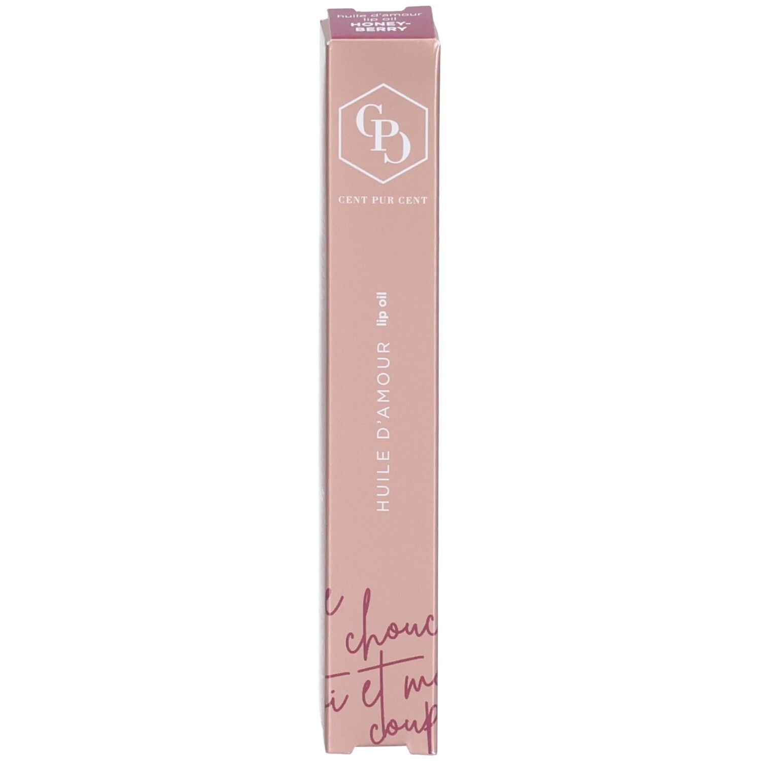 Emballage rose pour huile à lèvres. Le logo, le nom du produit et du texte sont visibles sur l'emballage.
