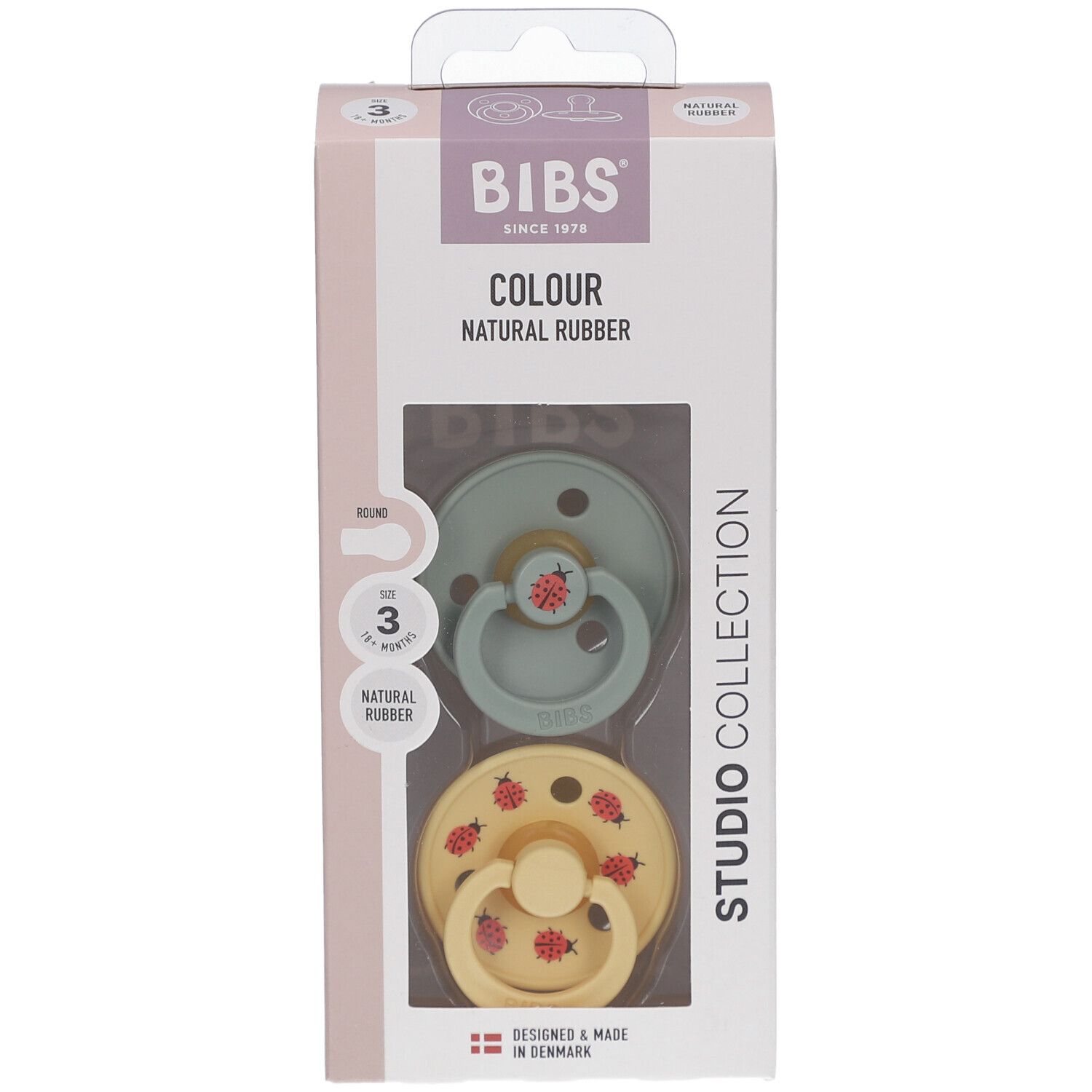 Verpackung mit zwei Schnullern. Grün und gelb mit roten Marienkäfern. Marke BIBS. Alter 18+ Monate.