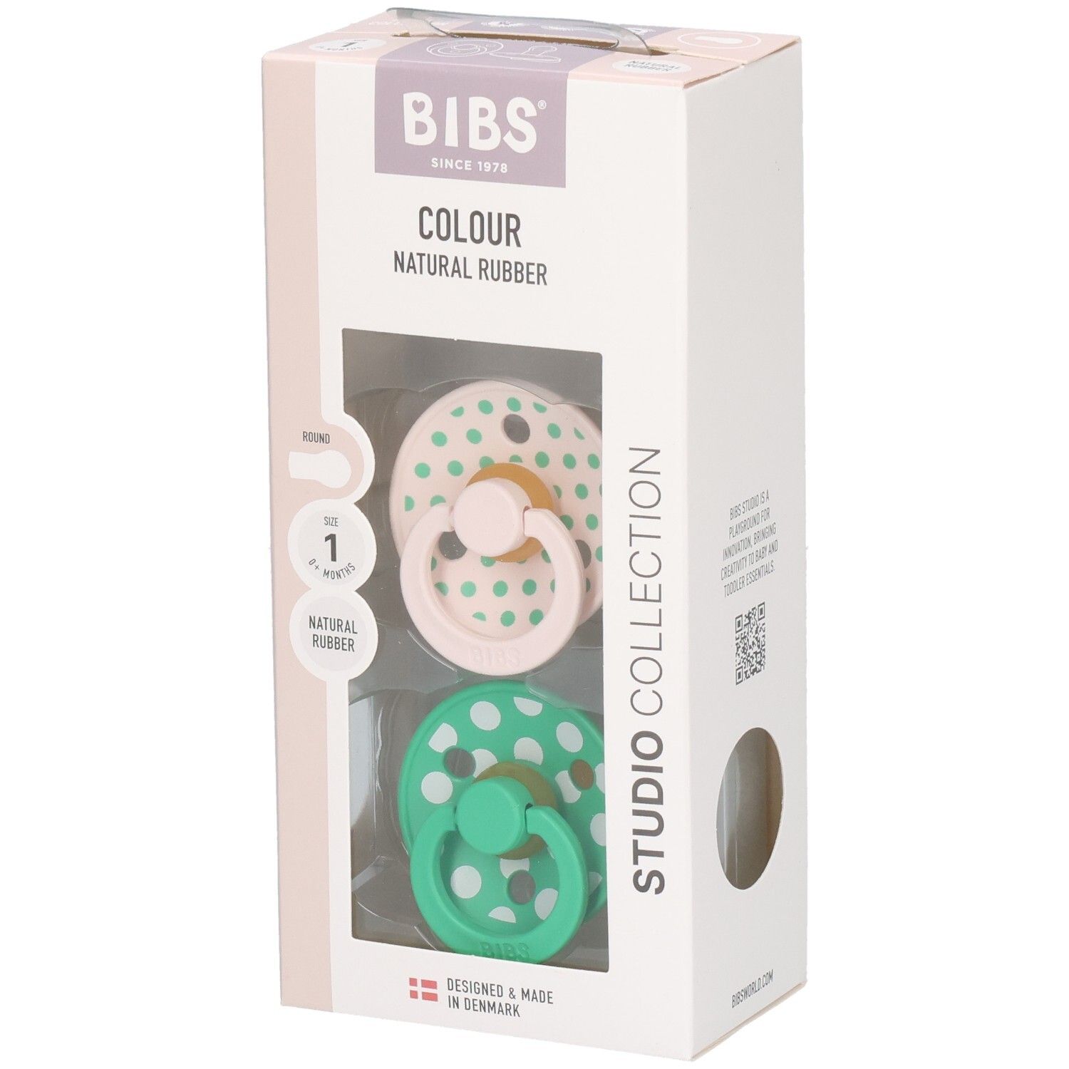 Verpackung mit zwei Schnullern. Rosa und grüne Schnuller mit weißen Punkten. Marke: BIBS. Naturgummi.