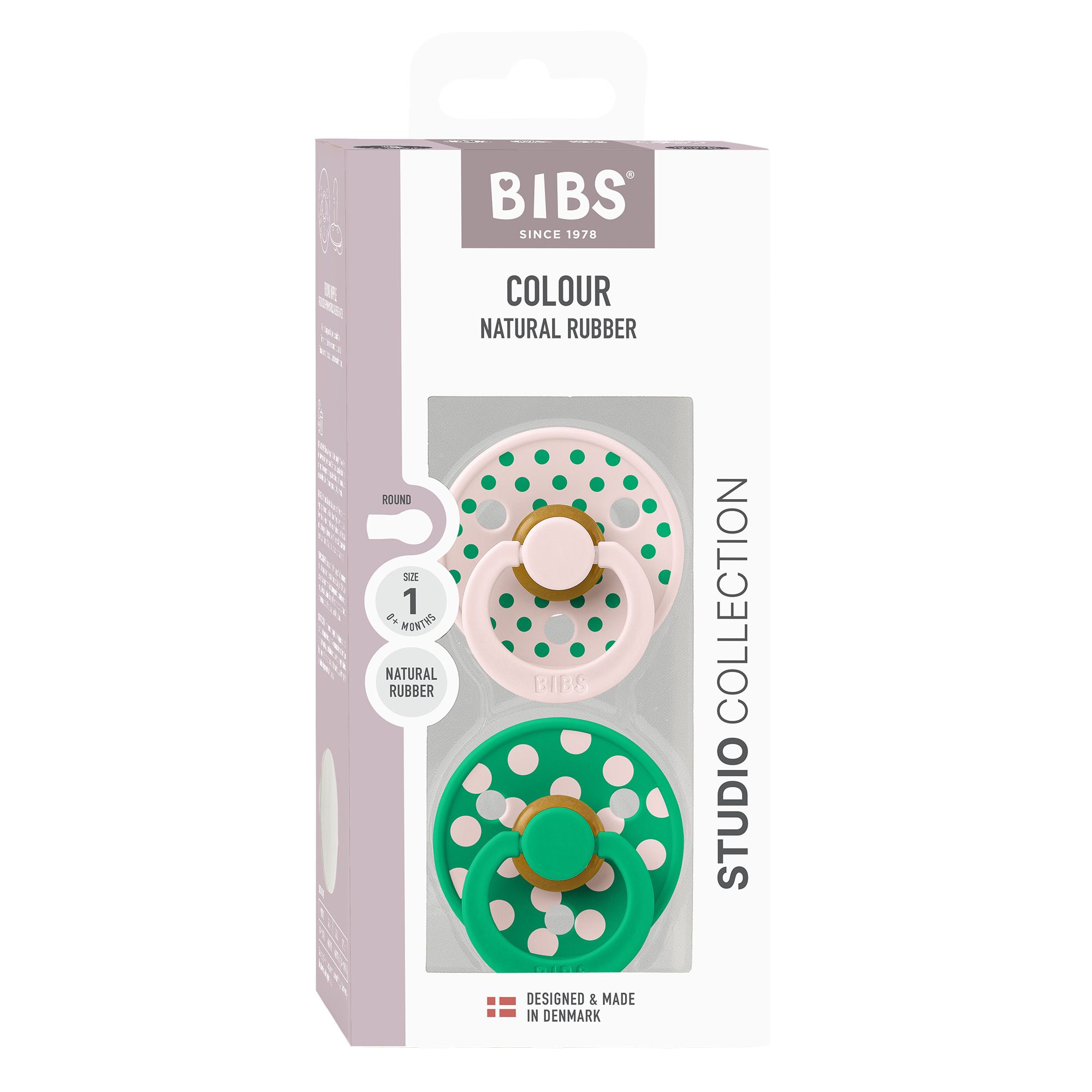 Boîte avec deux sucettes. Sucettes roses et vertes à pois blancs. Marque : BIBS. Caoutchouc naturel.
