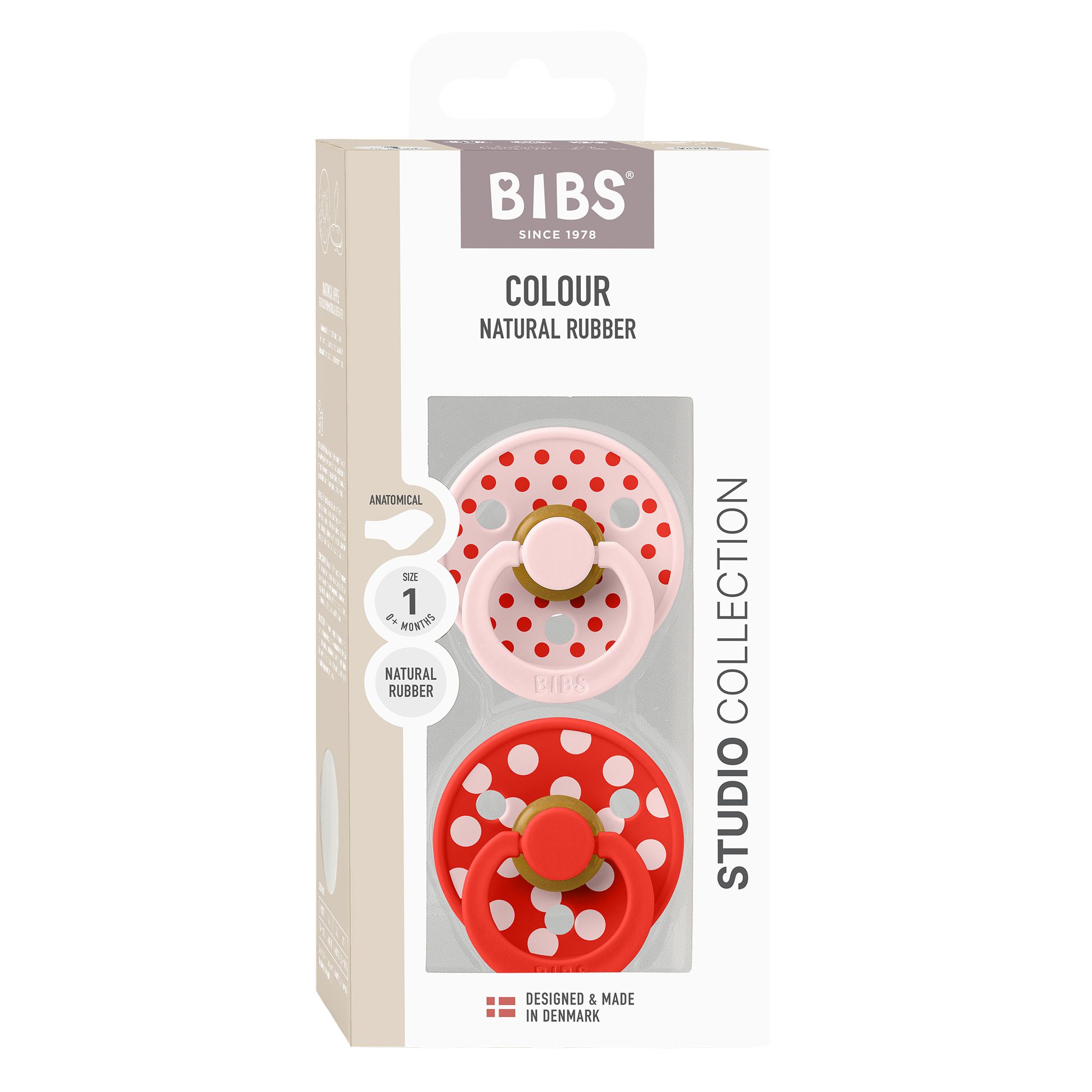 Deux sucettes BIBS: rose à pois blancs, anatomique. Rouge à pois blancs, anatomique.