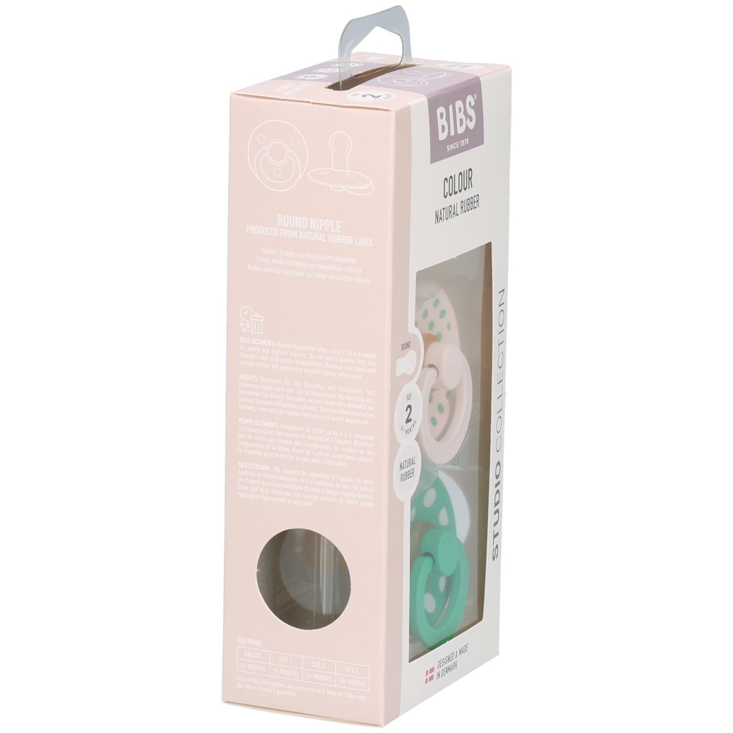 Boîte de deux sucettes. Sucettes roses et vertes à pois blancs. Marque : BIBS. Caoutchouc naturel.