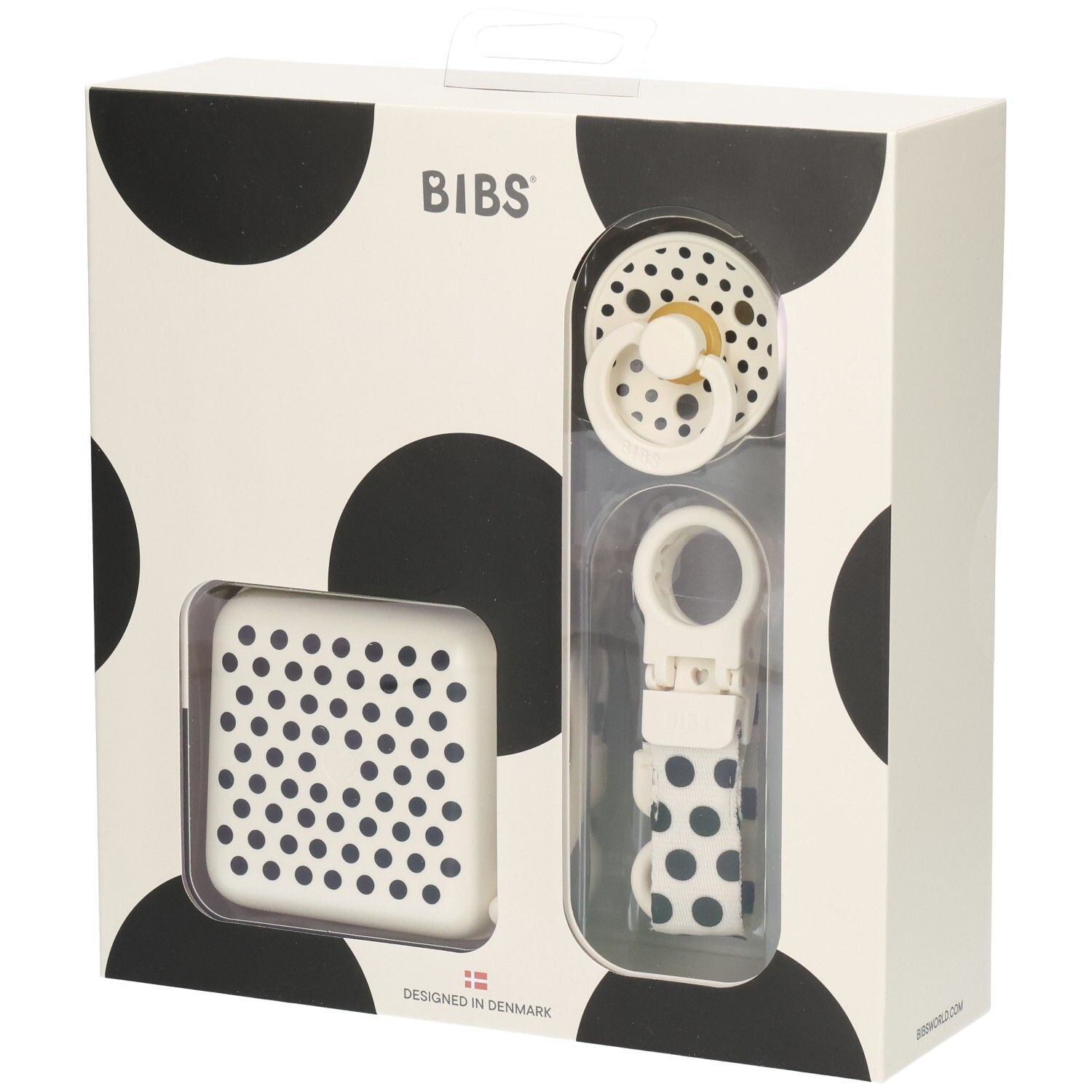 Geschenkset mit Schnuller, Schnullerbox und Schnullerband. Verpackung mit schwarzen Punkten. Marke BIBS.
