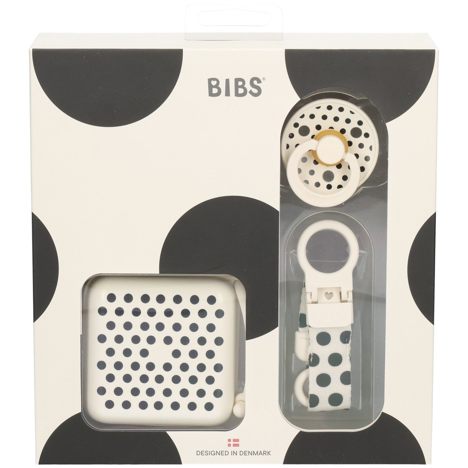 Geschenkset mit Schnuller, Schnullerbox und Schnullerband. Verpackung mit schwarzen Punkten. Marke BIBS.