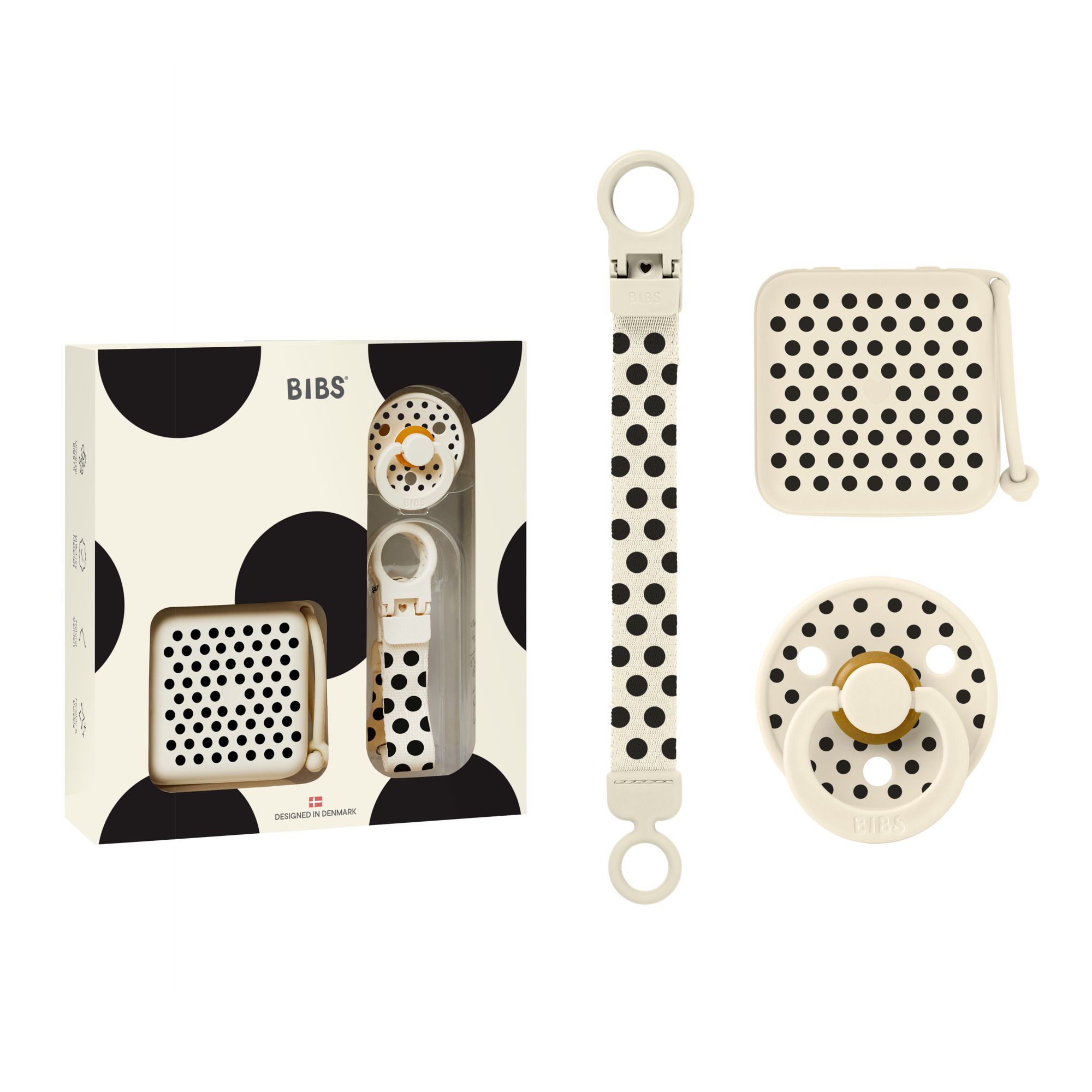 Coffret cadeau avec sucette, boîte et attache-sucette. Emballage à pois noirs. Marque BIBS.
