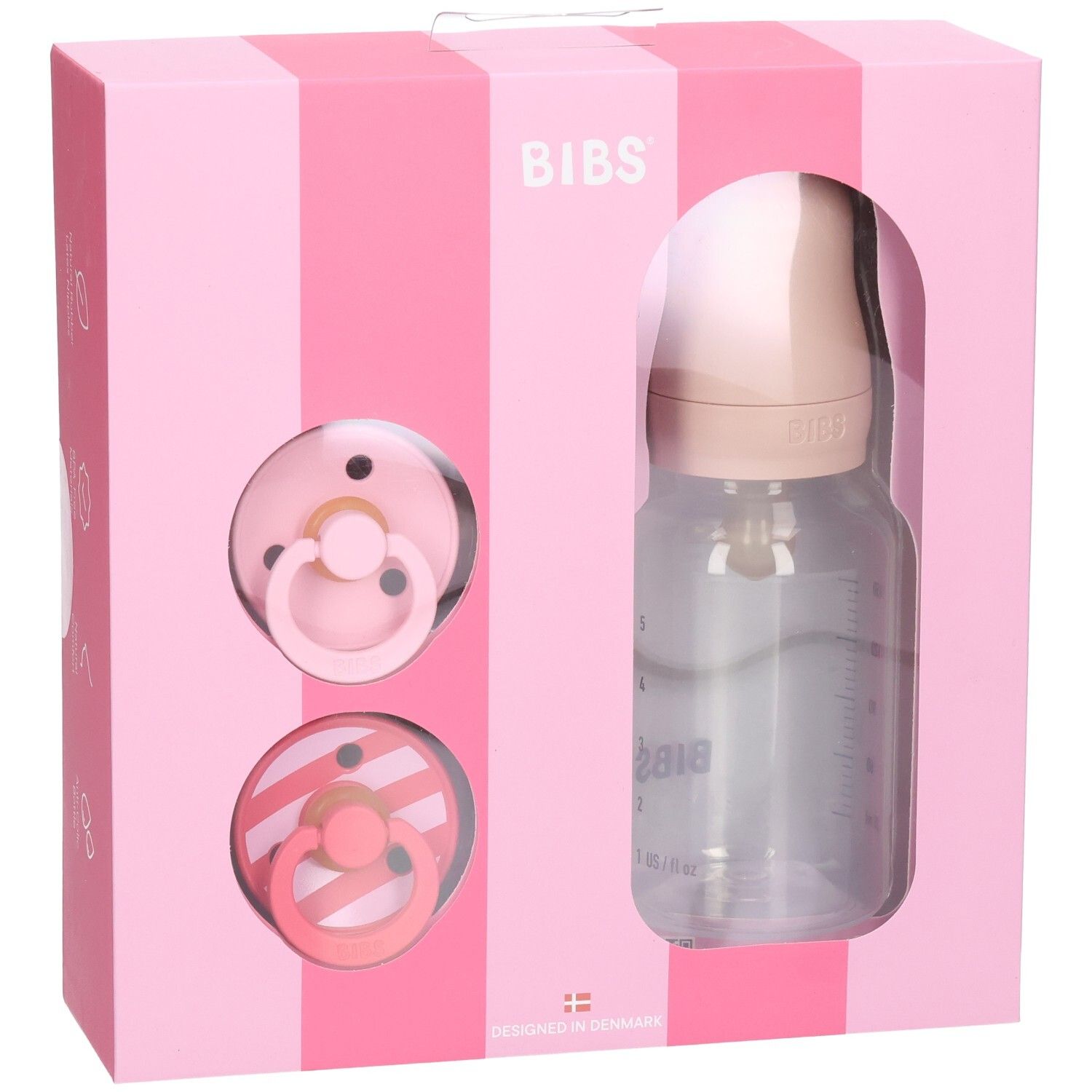 Rosa Geschenkbox mit Schnullern und Flasche. BIBS-Logo. Transparente Flasche mit Messskala. Zwei Schnuller.