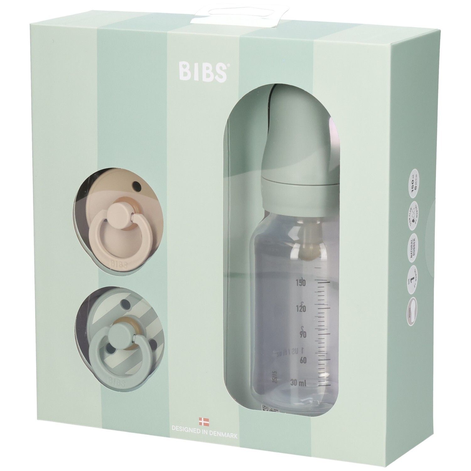 Coffret cadeau avec deux sucettes et un biberon dans une boîte. Le biberon a une échelle de mesure.