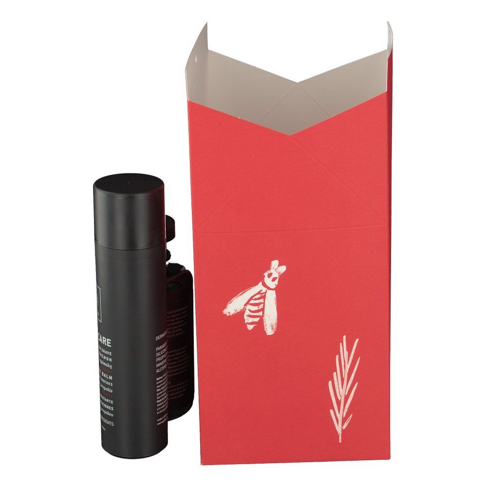 Schwarze Flasche und Sprühdose neben roter Geschenkbox. Auf der Box: Biene und Zweig-Illustrationen.