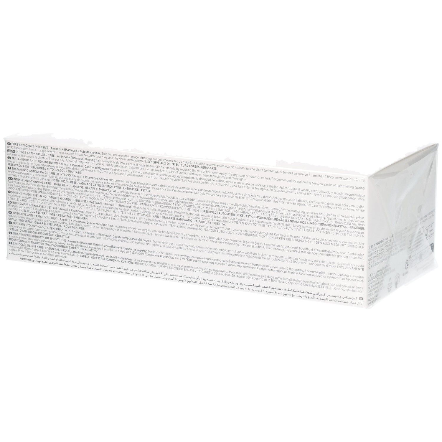 Lange Seite der Kérastase Genesis Cure Anti-Chute Intensive Box mit mehrsprachigen Texten.