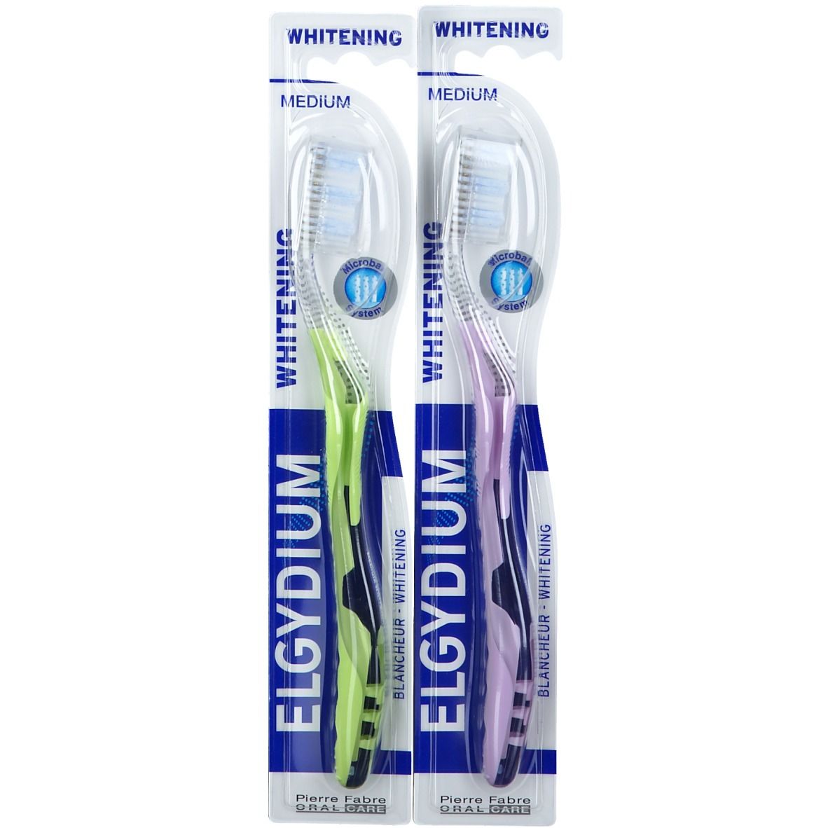 Zwei Zahnbürsten in Blisterverpackung. Grüne und lila Griffe. "ELGYDIUM" und "Whitening" Schriftzug.