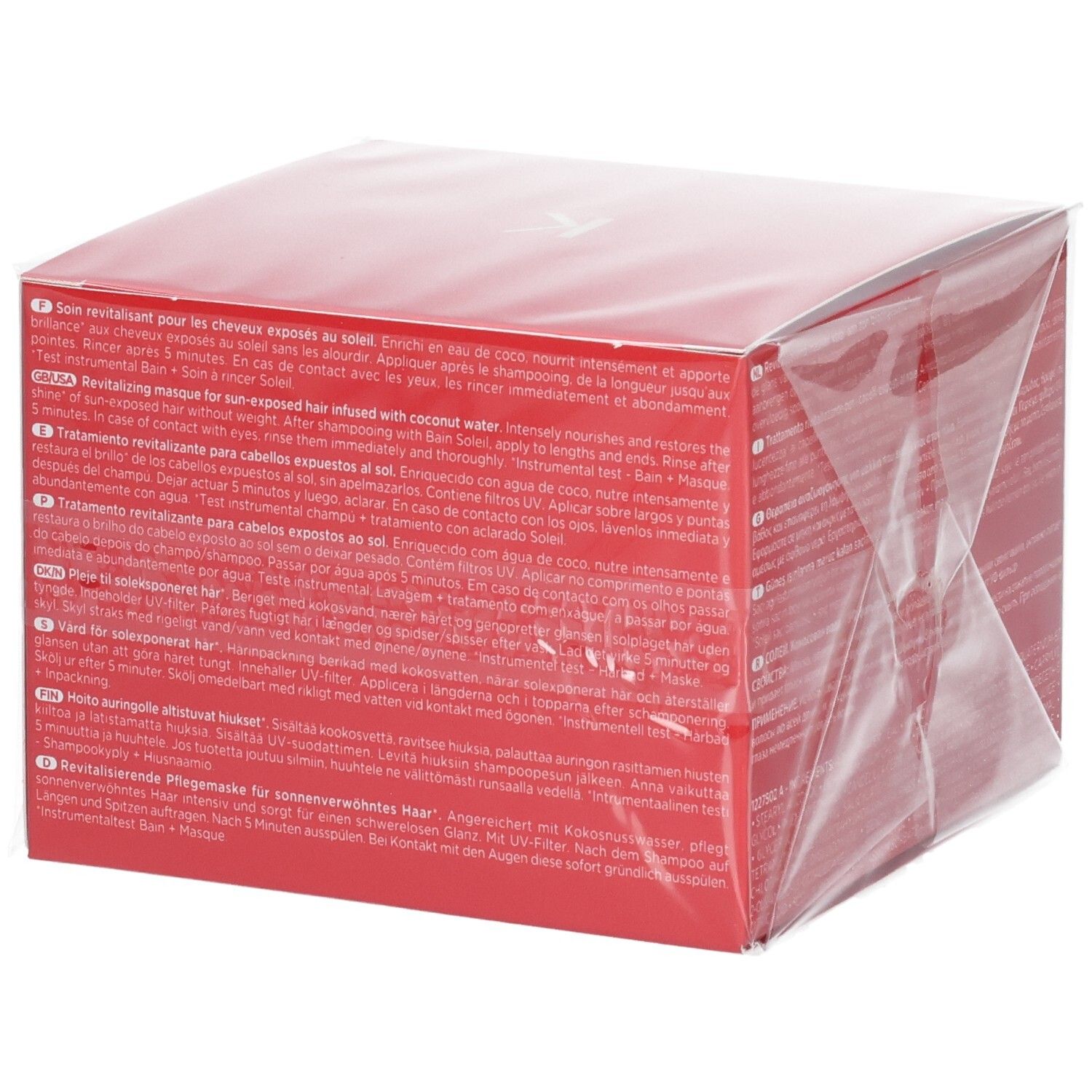 Emballage rouge Kérastase Soleil Après-Soleil avec description du produit en plusieurs langues, dont le français.