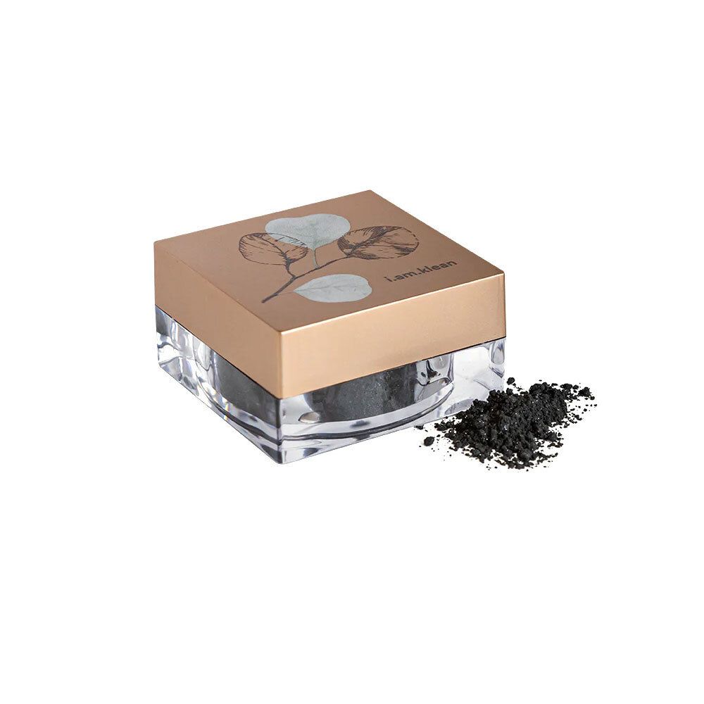 Pot carré avec couvercle doré et motif de feuilles. Contient de l'ombre à paupières noire libre.