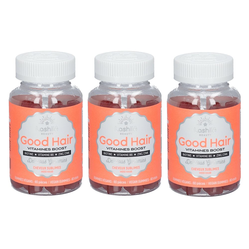 Trois flacons de Good Hair Lashilé Beauty. Étiquettes oranges, bouchons blancs. Texte: Vitamines Boost, Biotine, Zinc, B6.