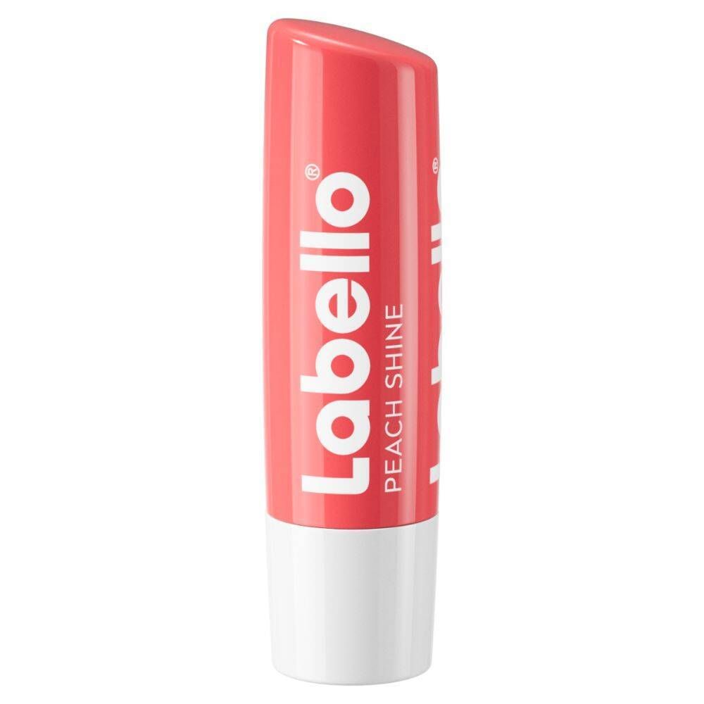 Stick de soin pour les lèvres Labello Peach Shine. Étui rose, base blanche. Inscription Labello et Peach Shine.