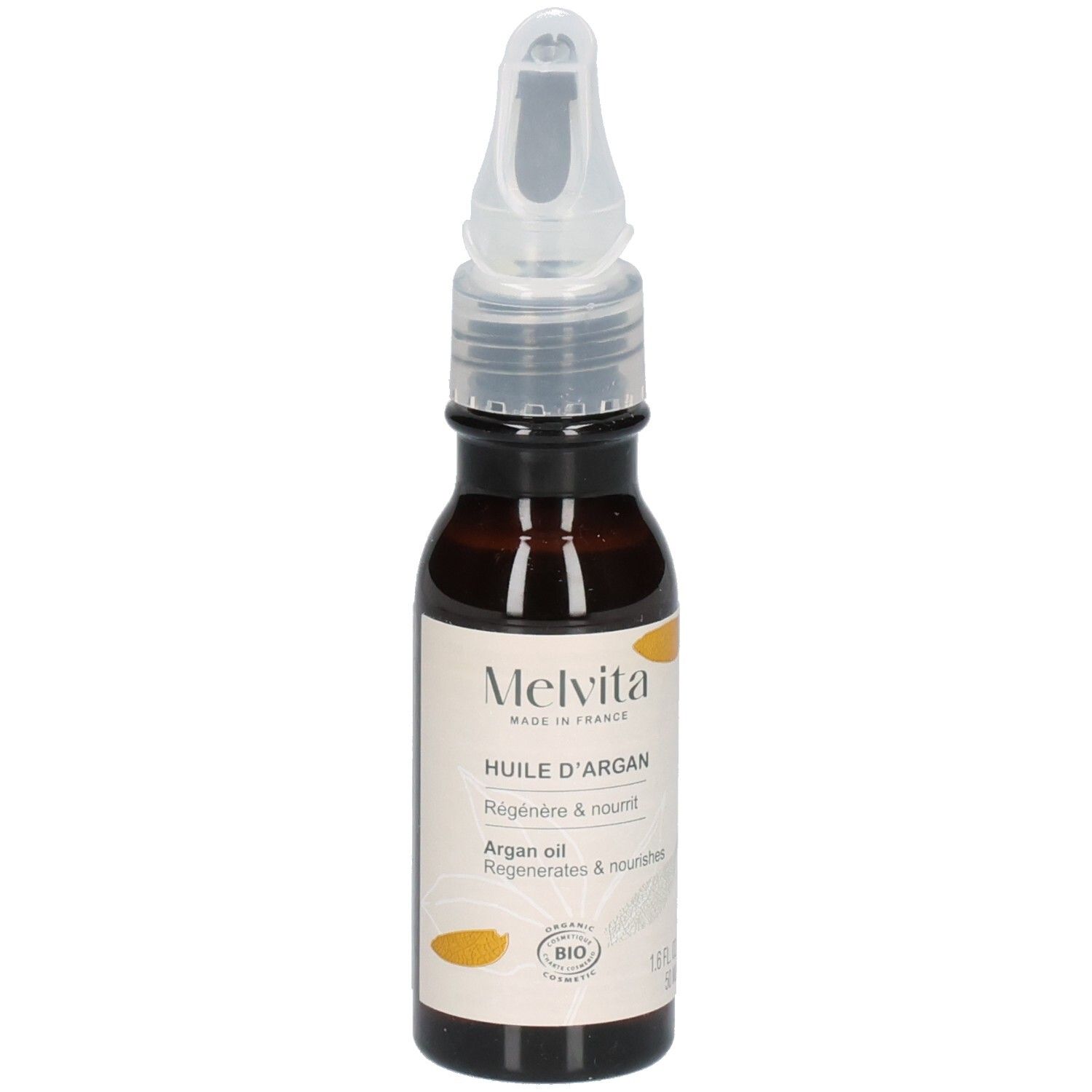 Melvita Arganöl Flasche mit Applikator, umgeben von Arganfrüchten.