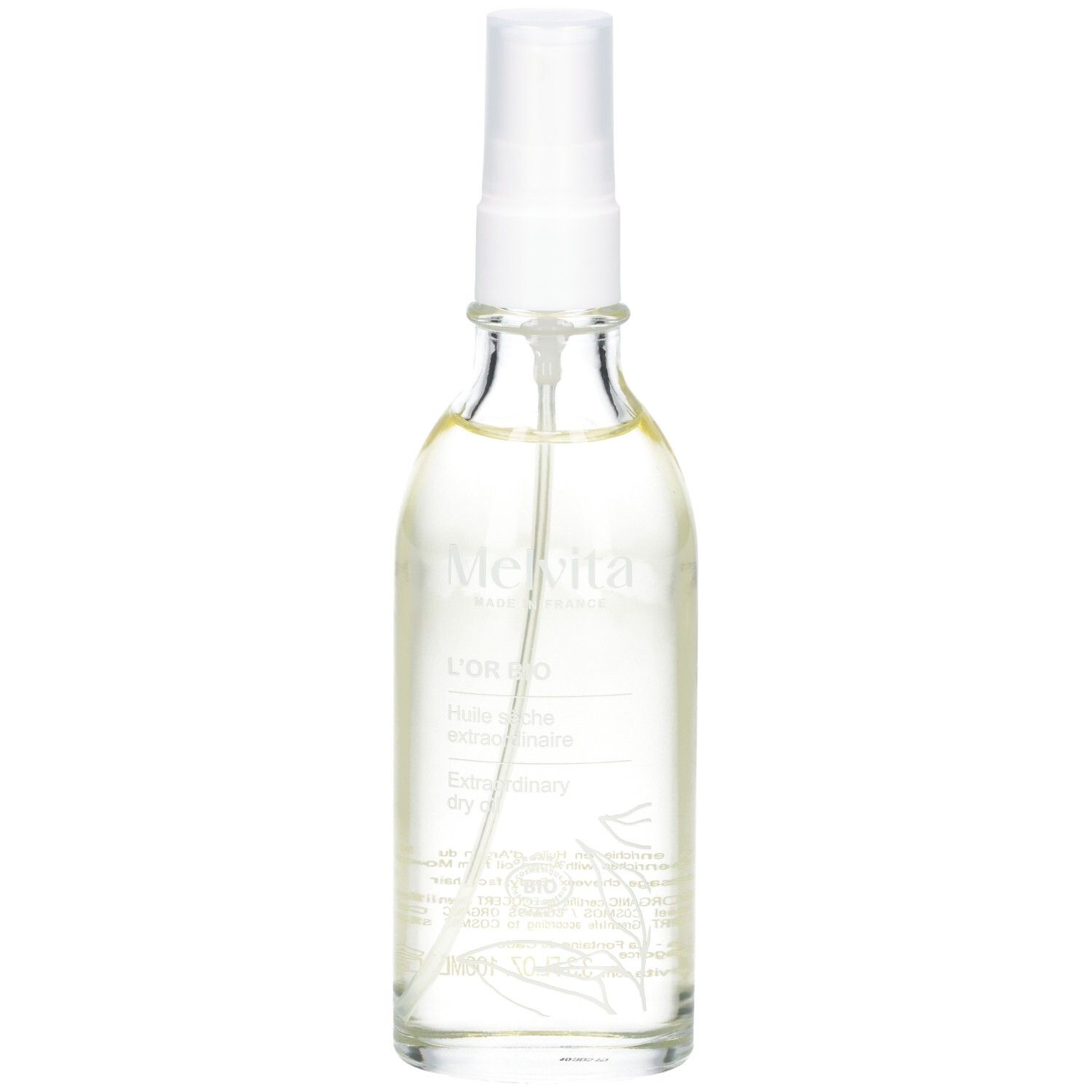 Klare Glasflasche mit Sprühkopf. Enthält goldfarbenes Öl. Etikett mit Text.