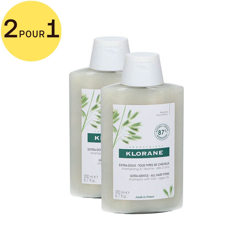 Deux flacons de shampooing Klorane. Inscription: Extra-Doux, 2 pour 1. 87% ingrédients naturels.