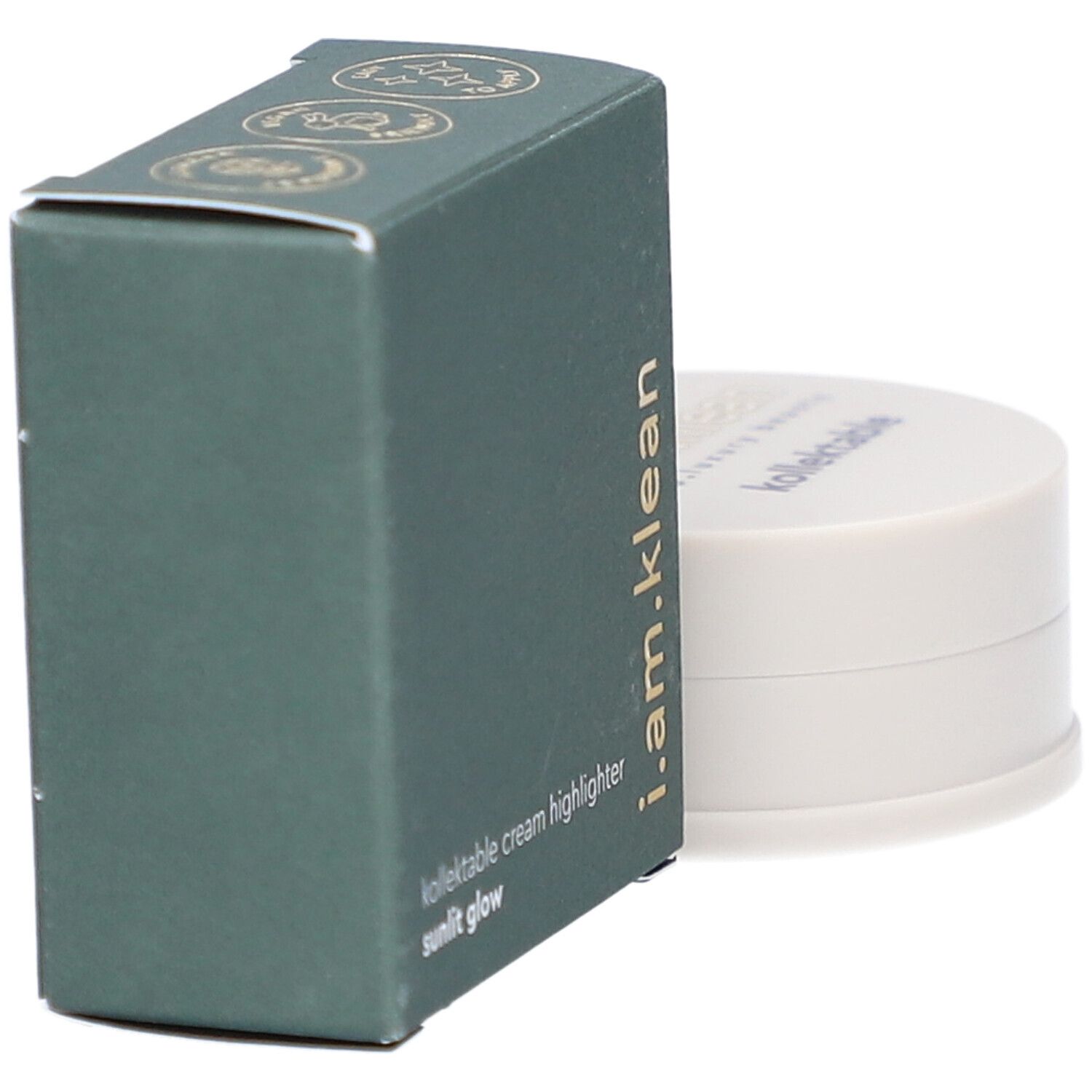 Grüne Schachtel und cremefarbener Behälter. Auf der Schachtel steht i.am.klean, kollektable cream highlighter sunlit glow. Der Behälter hat einen Deckel mit Schriftzug.