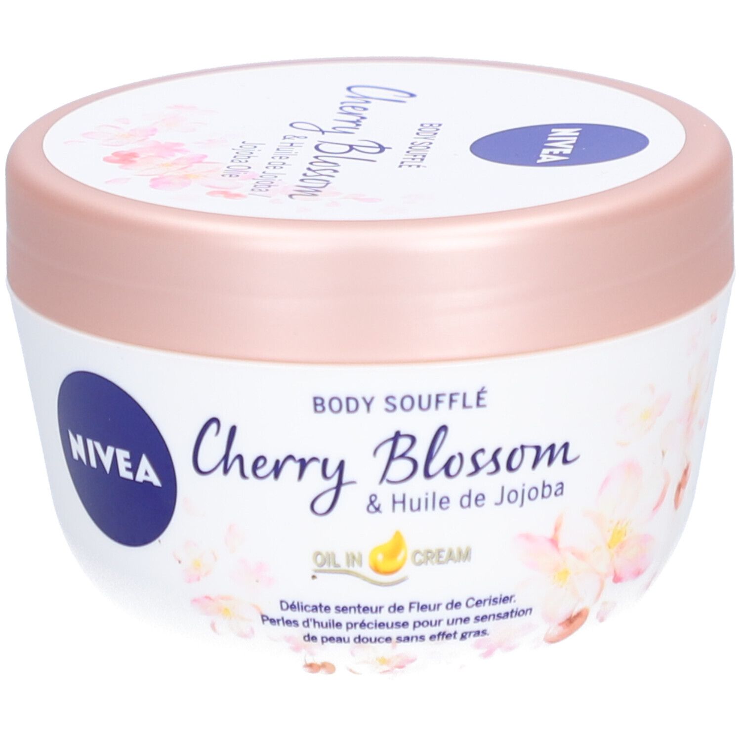 Pot blanc avec couvercle rose. Inscription : NIVEA, Body Soufflé Cherry Blossom & Jojoba Olie. Motif floral.