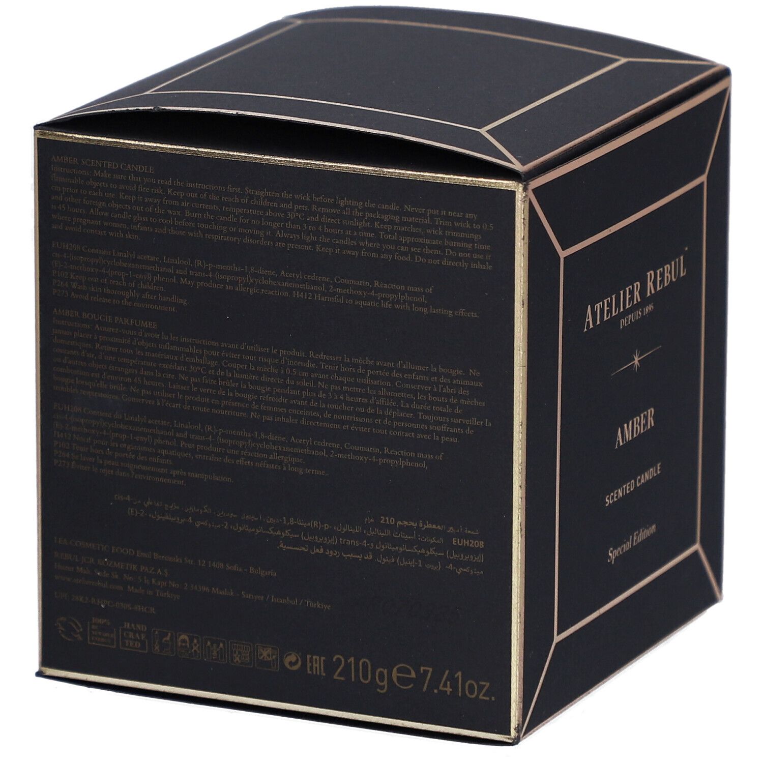 Rückseite einer schwarzen quadratischen Schachtel mit goldfarbenen Akzenten. Text in mehreren Sprachen. Volumenangabe: 210g 7.41oz.