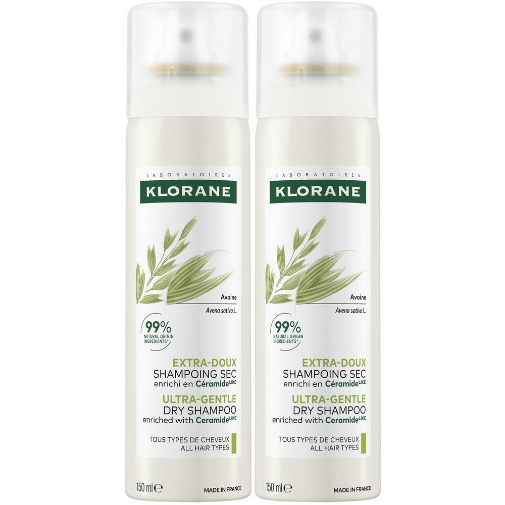 Deux flacons de shampooing sec. Blancs, étiquettes vertes et beiges. Têtes de pulvérisation.