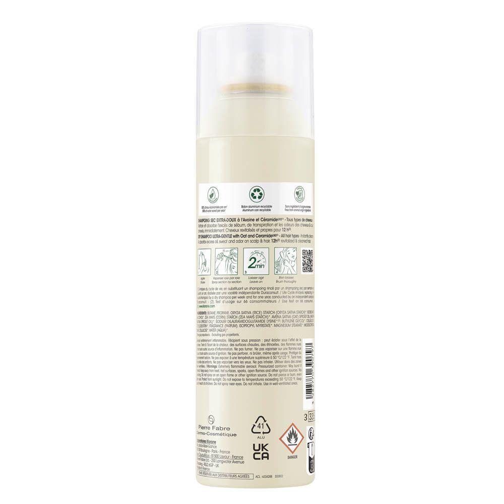 Dos d'un flacon de shampooing sec. Texte et pictogrammes. Fond vert.