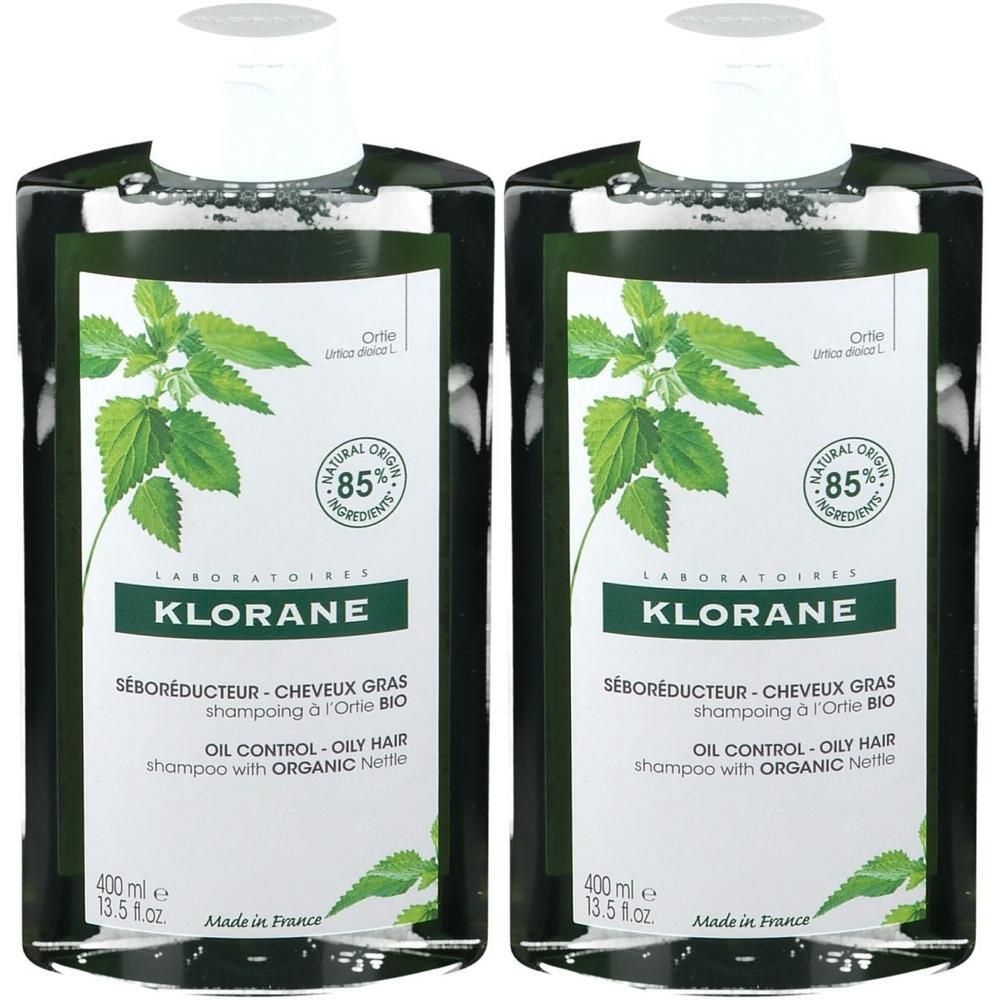 Zwei Flaschen KLORANE Shampoo. Grün-weißes Etikett mit Brennnessel-Illustration. Text: Seboréducteur, 85% natürliche Inhaltsstoffe.