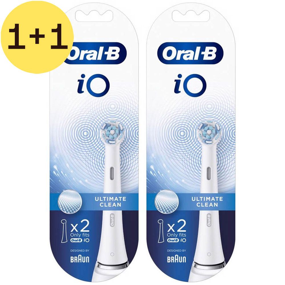 Deux têtes de brosse Oral-B iO Ultimate Clean. Têtes de brosse blanches avec soies bleues. Emballage avec inscription 'Ultimate Clean'.