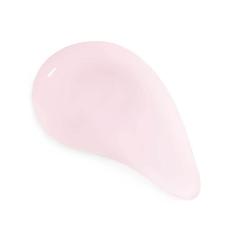 Goutte de crème rose sur fond blanc.