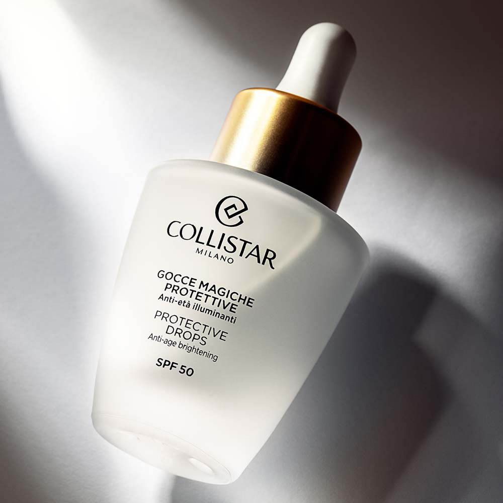 Flacon avec compte-gouttes. Verre blanc mat. Bouchon doré. Inscription : Collistar, Protective Drops, SPF 50.