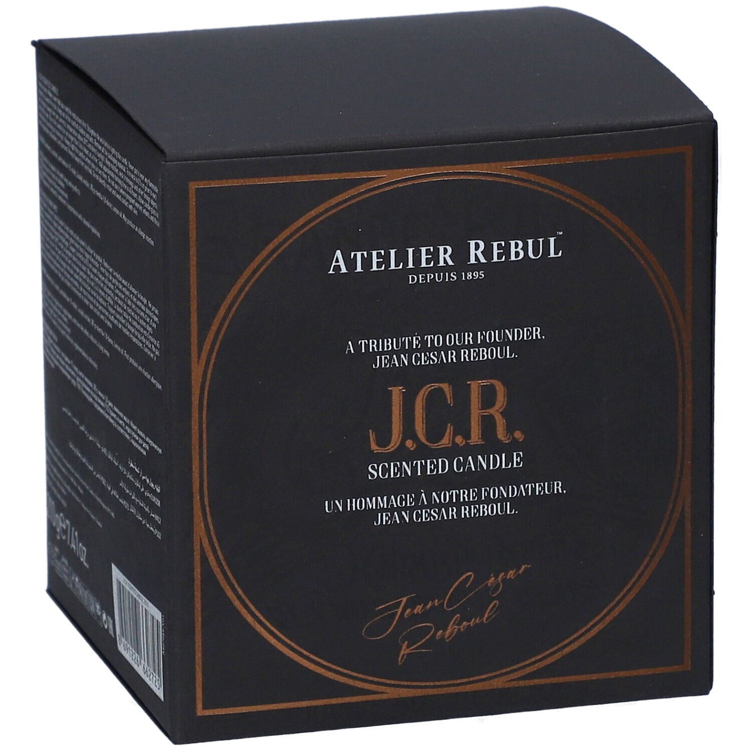 Schwarze quadratische Schachtel mit goldfarbenem Aufdruck. Text: Atelier Rebul, J.C.R. Scented Candle. Signatur.