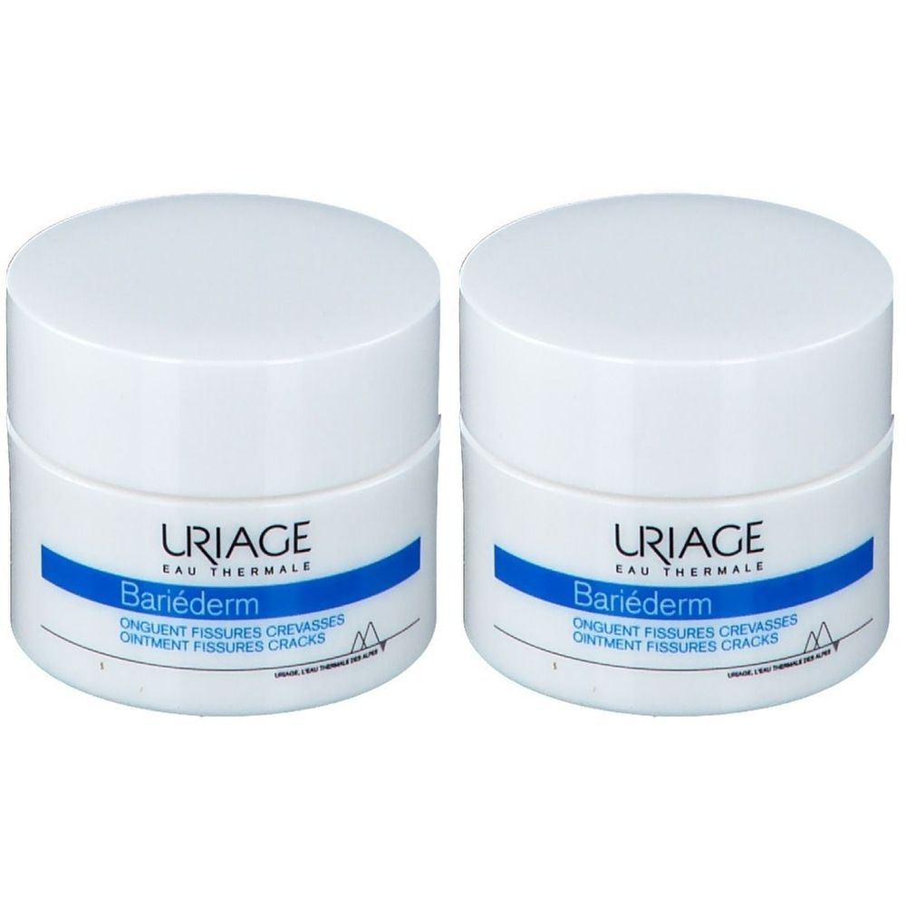 Zwei weiße Tiegel URIAGE Bariéderm, blaue Banderole, Schriftzug. Produkt gegen Risse.