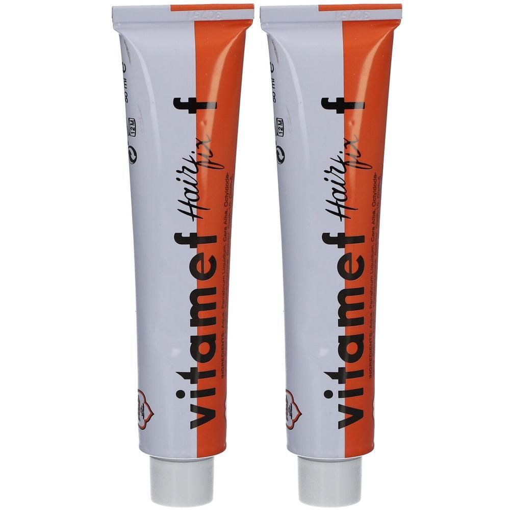 Zwei Tuben Vitamef Hairfix. Weiße Tuben mit orangefarbenem Streifen und Schriftzug. Rote Logos und Schrift.