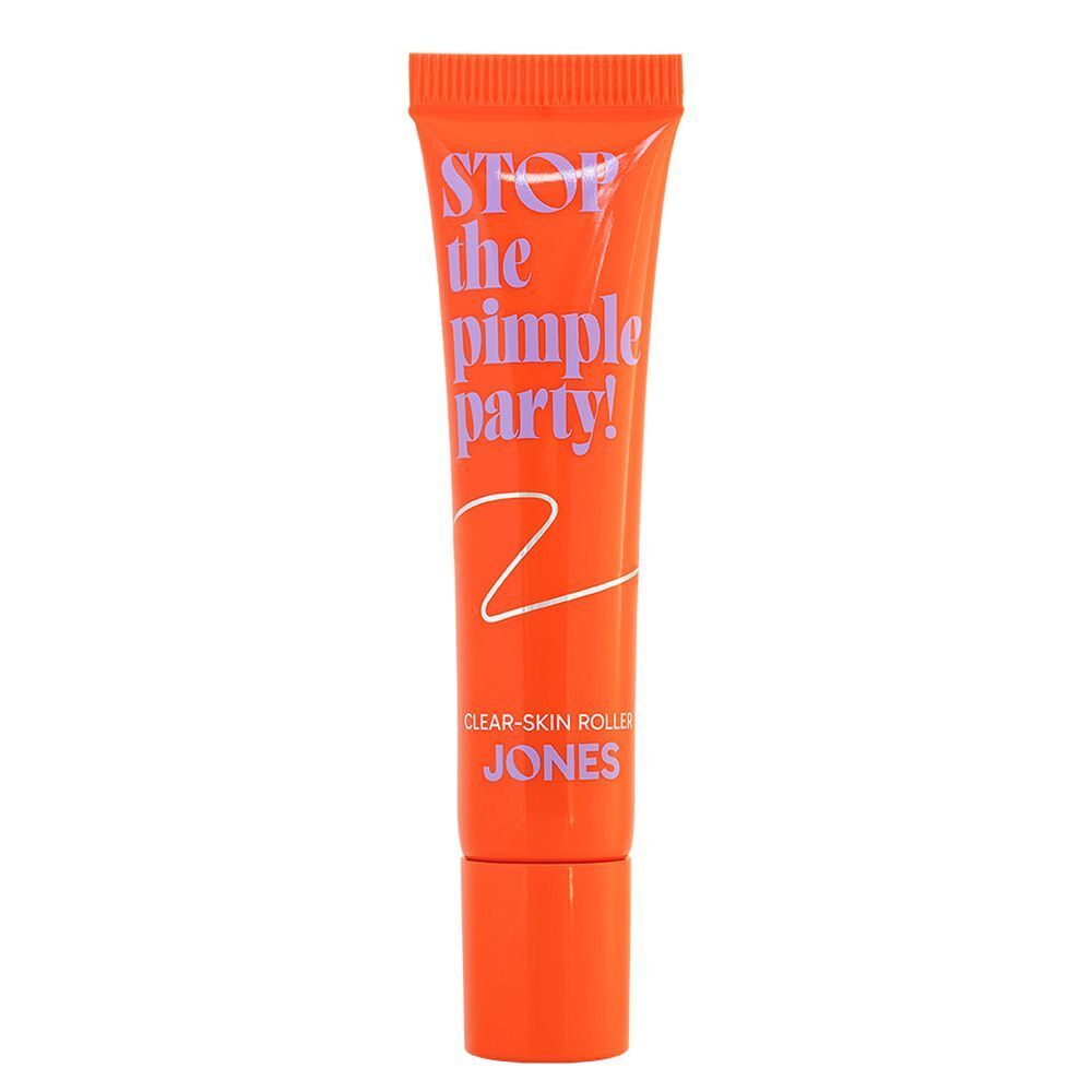 Tube orange avec texte. Texte : Stop the Pimple Party! Clear-Skin Roller. Marque : JONES.