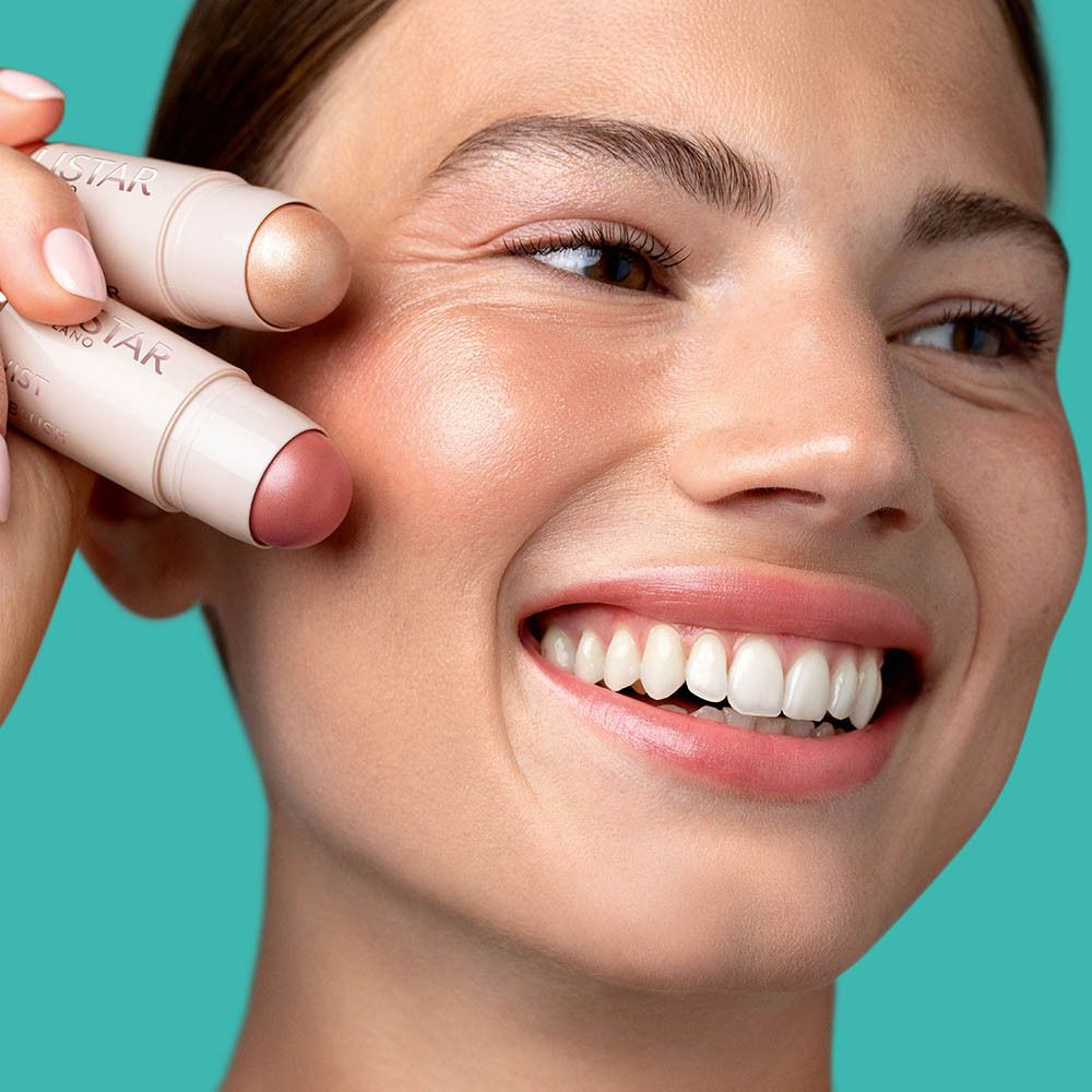 Femme avec stick de blush. Collistar Milano, Twist Glowy Blush. Appliqué sur les joues.