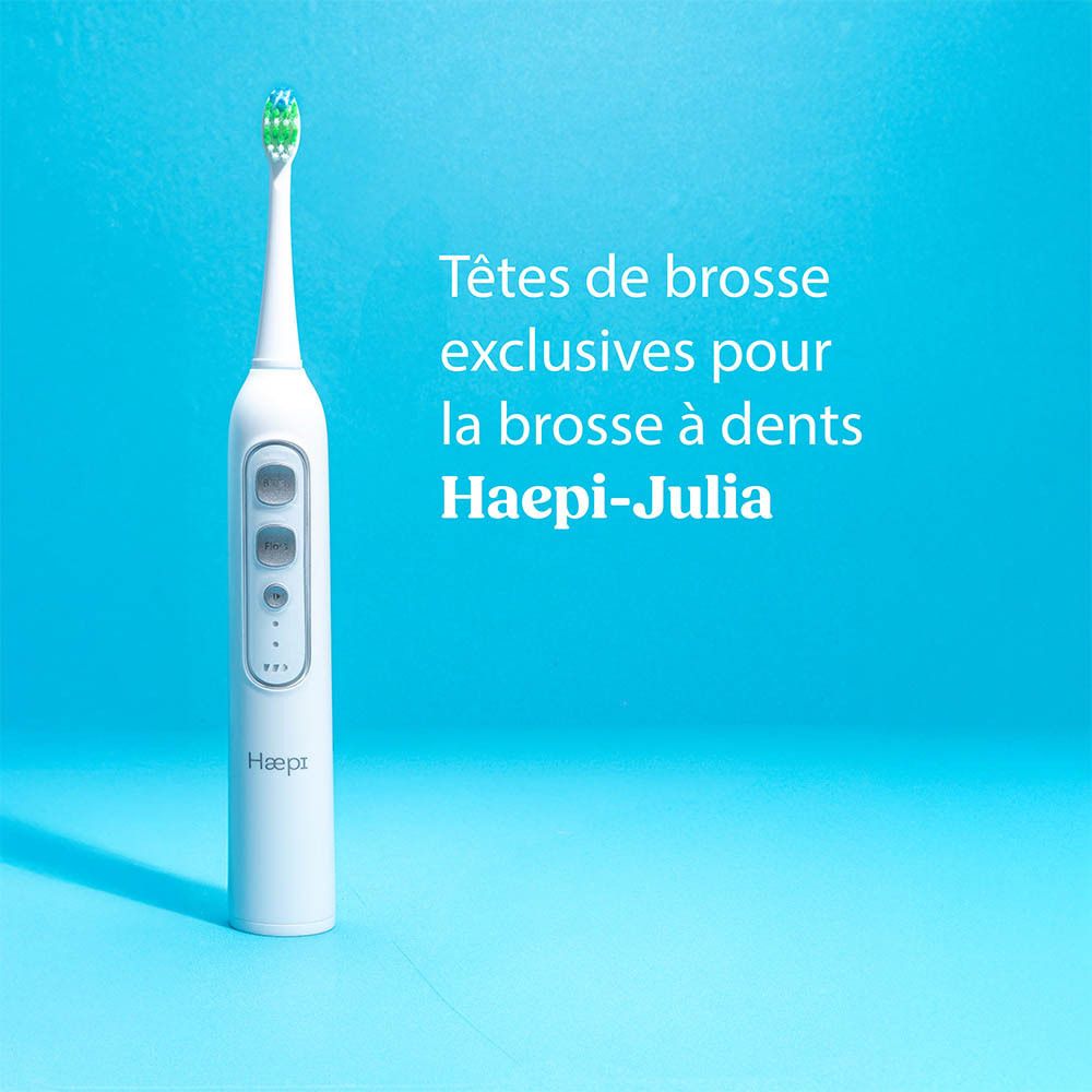 Brosse à dents électrique Haepi-Julia. Corps blanc avec boutons. Fond bleu.