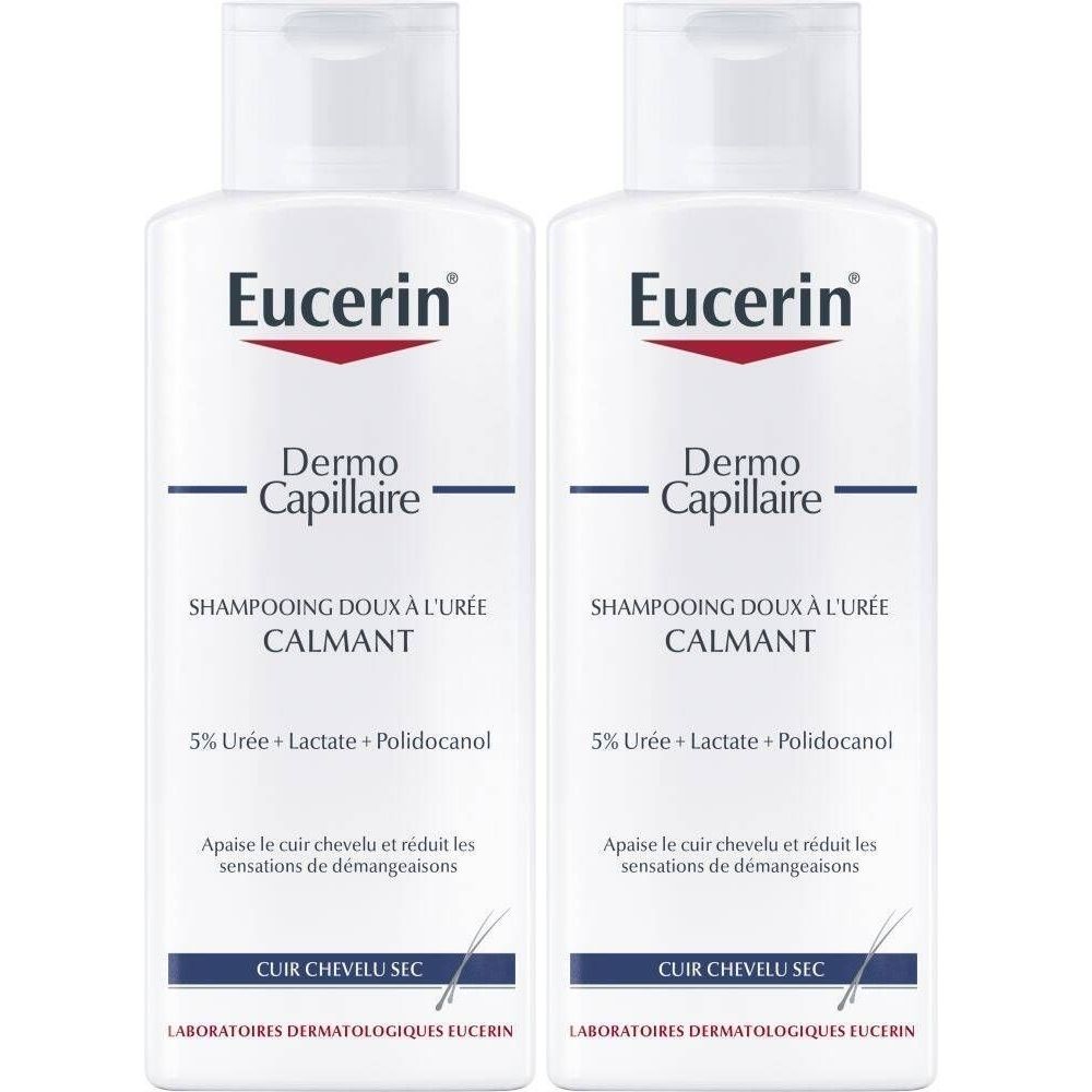 Zwei weiße Flaschen Eucerin DermoCapillaire Shampoo. Aufschrift: SHAMPOOING DOUX À L'URÉE CALMANT. Für trockene Kopfhaut. Mit rotem Logo.