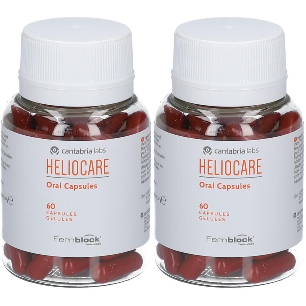 Deux flacons de Heliocare Oral Capsules. Flacons transparents avec bouchons blancs et étiquettes. Gélules rouges visibles.