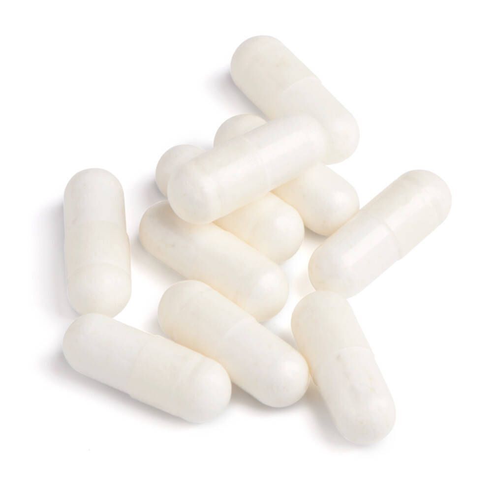 Haufen weißer Kapseln. Keine Verpackung sichtbar.