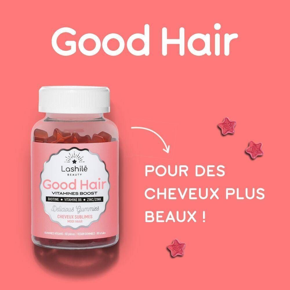 Un flacon de gummies. Inscription : Good Hair, Vitamines Boost. Contient de la biotine, de la vitamine B6, du zinc. Fond rose avec gummies étoiles.