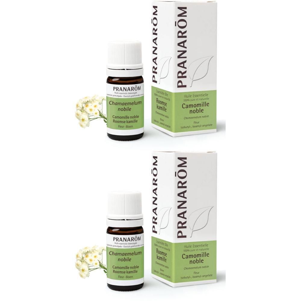 Zwei Flaschen und Verpackungen. Flaschen mit weißem Deckel, braunem Glas. Verpackung weiß mit grünem Akzent und Schriftzug.